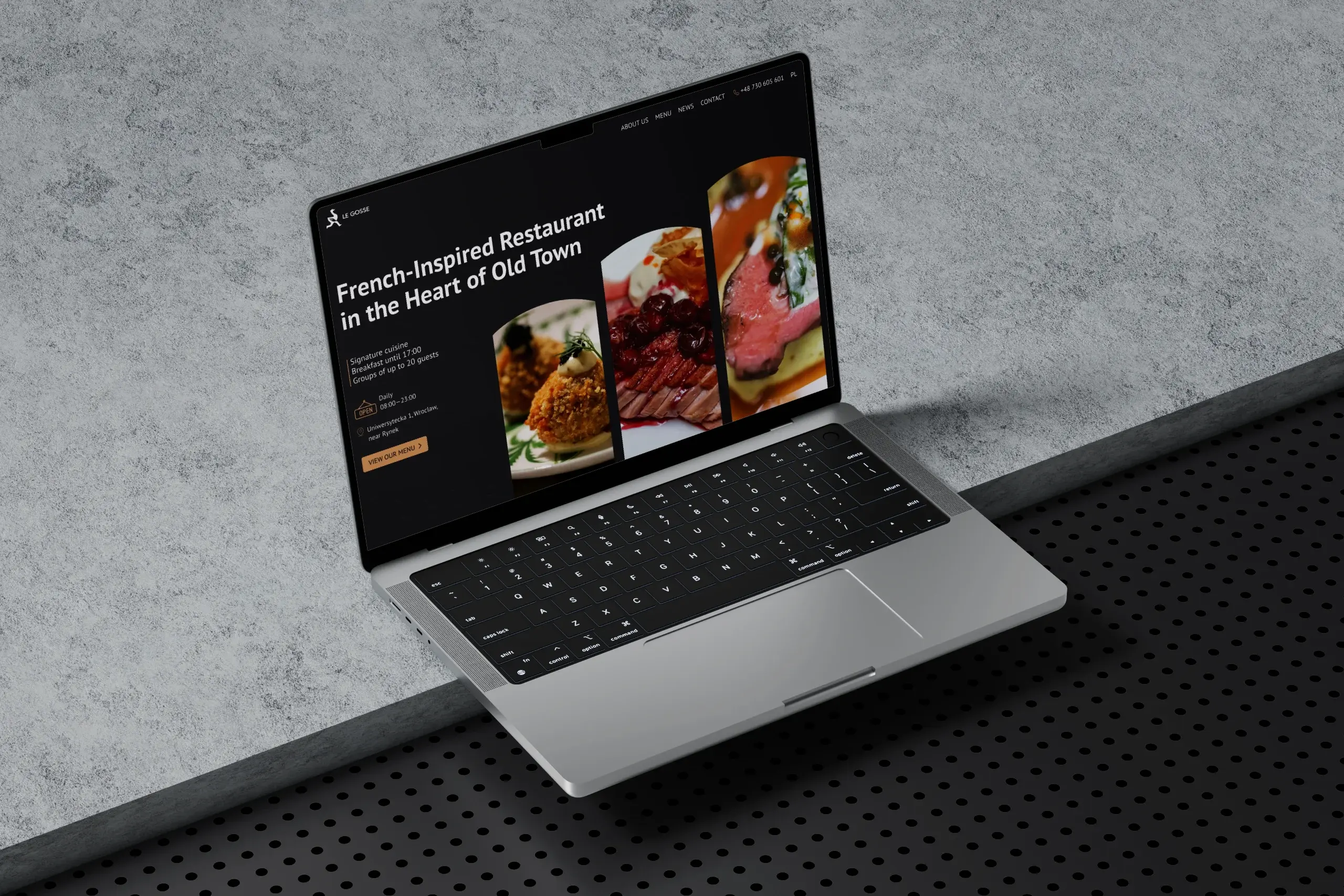 French restaurant website hero section featured on a laptop display.